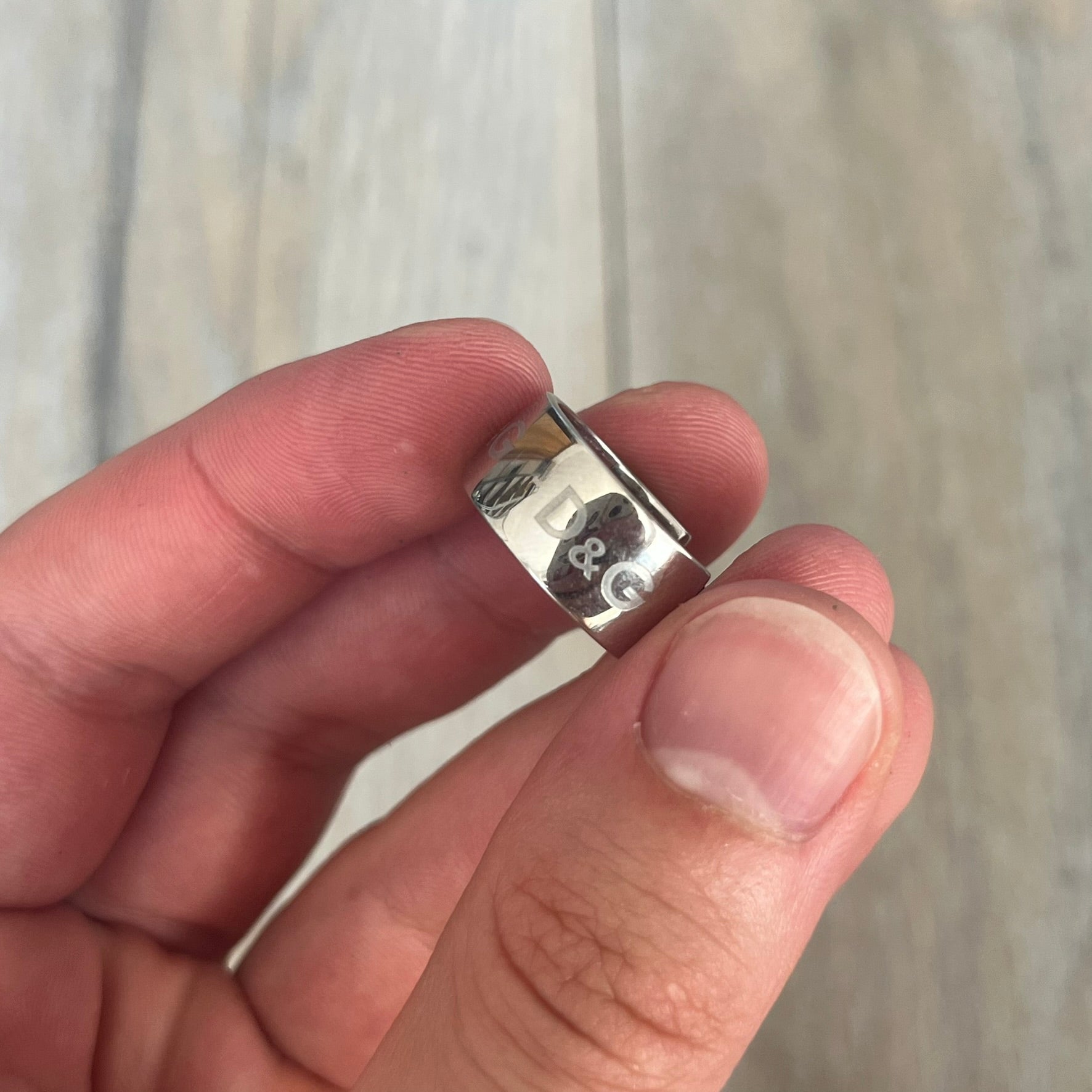 Dolce &amp; Gabbana DJ0404 D&amp;G Logo Earrings are a pair of 2000s silver-tone hoop earrings with a wide profile. The earrings feature an engraved repeating D&amp;G logo around the outer surface. They have a hinged hoop design with a straight post closure and a polished metal finish.