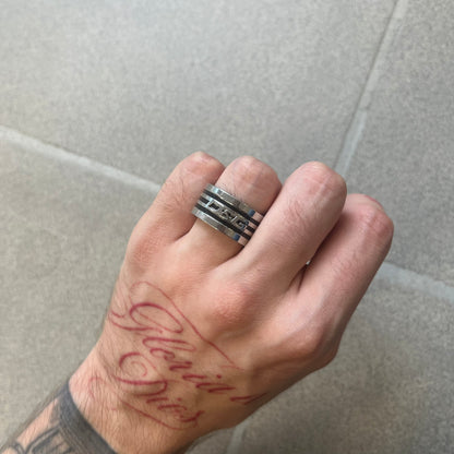 Dolce &amp; Gabbana stainless steel ring DJ0709 in silver, featuring three subtle black engraved stripes encircling the band. The D&amp;G logo is displayed in polished silver on top, creating a nice contrast with the dark detailing.