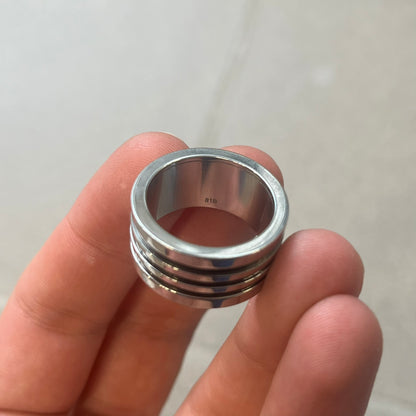 Dolce &amp; Gabbana stainless steel ring DJ0709 in silver, featuring three subtle black engraved stripes encircling the band. The D&amp;G logo is displayed in polished silver on top, creating a nice contrast with the dark detailing.