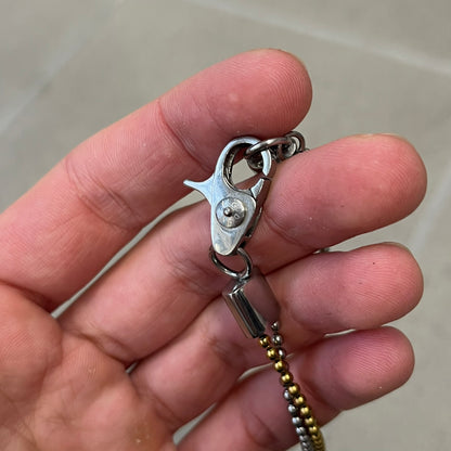 Dolce &amp; Gabbana 2000's Gold Heart DJ0637 Necklace features a stainless steel ball &nbsp;chain, one in silver-tone, the second in gold-tone, with a dog tag-style pendant. The pendant is engraved with a subtle "I" above a gold-tone heart secured by three visible screws, with "D&amp;G" engraved below to form the "I ❤️ D&amp;G" design.&nbsp;
