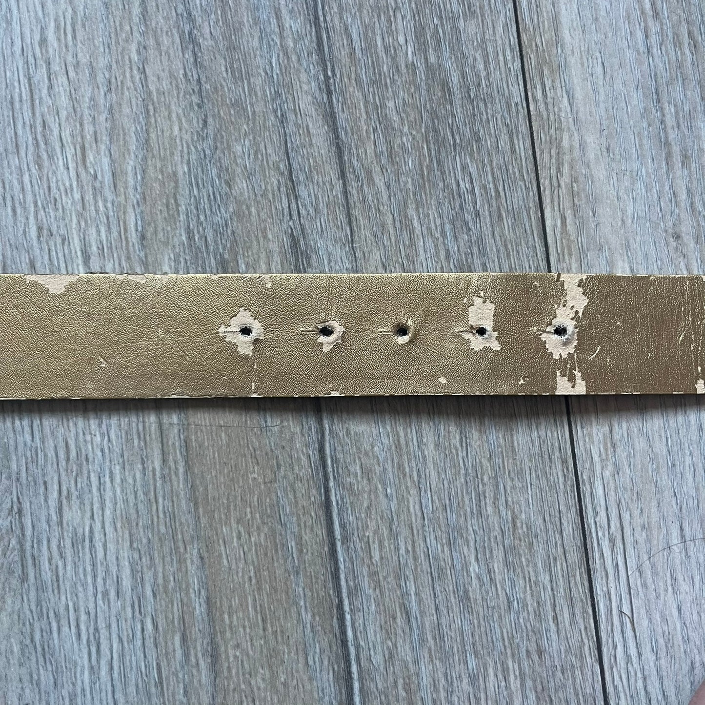 The Dolce & Gabbana 2000’s Gold Tone D&G Logo Belt is made from metallic gold leather and features a large D&G logo buckle shaped directly as the brand’s initials. The buckle uses a cursive D&G logo set over a glittery gold background, framed by a solid gold-tone metal outline. The entire buckle and belt maintain a consistent gold color scheme typical of Dolce & Gabbana accessories from the 2000s.