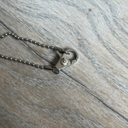 Dolce &amp; Gabbana 2000s Layered Gold/Silver Necklace DJ0721 is a chain necklace featuring a steel ball chain with lobster clasp engraved with D&amp;G branding. The pendant is constructed in a layered design with three sections: a gold-tone middle layer and silver-tone top and bottom layers. The front and back includes a cut-out D&amp;G logo with an outlined frame