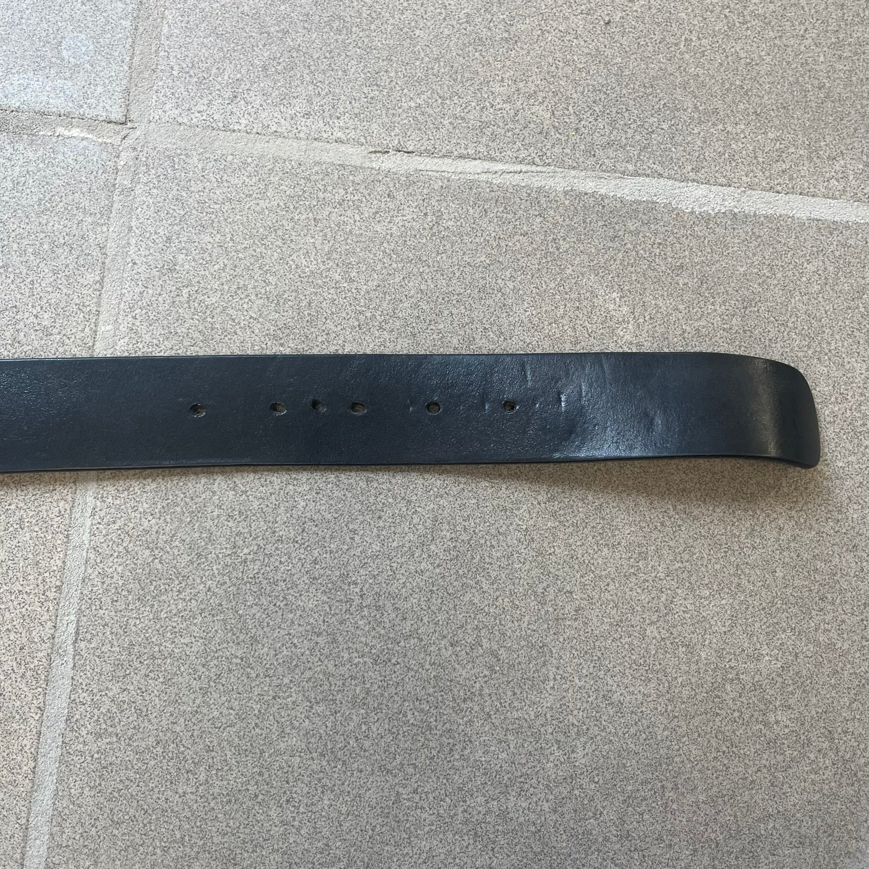 Dolce &amp; Gabbana "Made with Pride" Belt features a circular silver buckle with D&amp;G 94 at the center, surrounded by “Proud to Wear D&amp;G,” “Made with Pride,” and “Established 1994” text. Finished with subtle red and navy accents, it comes with a non-D&amp;G basic black leather belt.