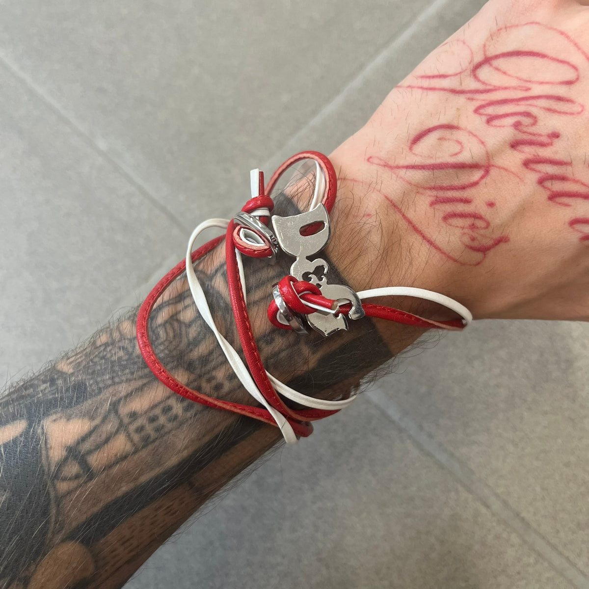 Dolce &amp; Gabbana 2000s Red &amp; White Strings Necklace &amp; Bracelet is a versatile accessory featuring red and white leather cords joined with stainless steel end caps. The center is finished with a stainless steel D&amp;G logo, while the back of the logo features a small engraved D&amp;G mark. Designed to be worn either as a necklace or wrapped as a bracelet.