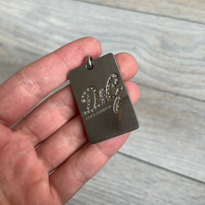 Dolce &amp; Gabbana Rhinestones Dog Tag Necklace DJ0704 crafted from polished stainless steel. Features a rectangular pendant with the iconic D&amp;G logo detailed in rhinestones, and “Dolce &amp; Gabbana” engraved subtly below. Comes with a basic non-D&amp;G steel ball chain.