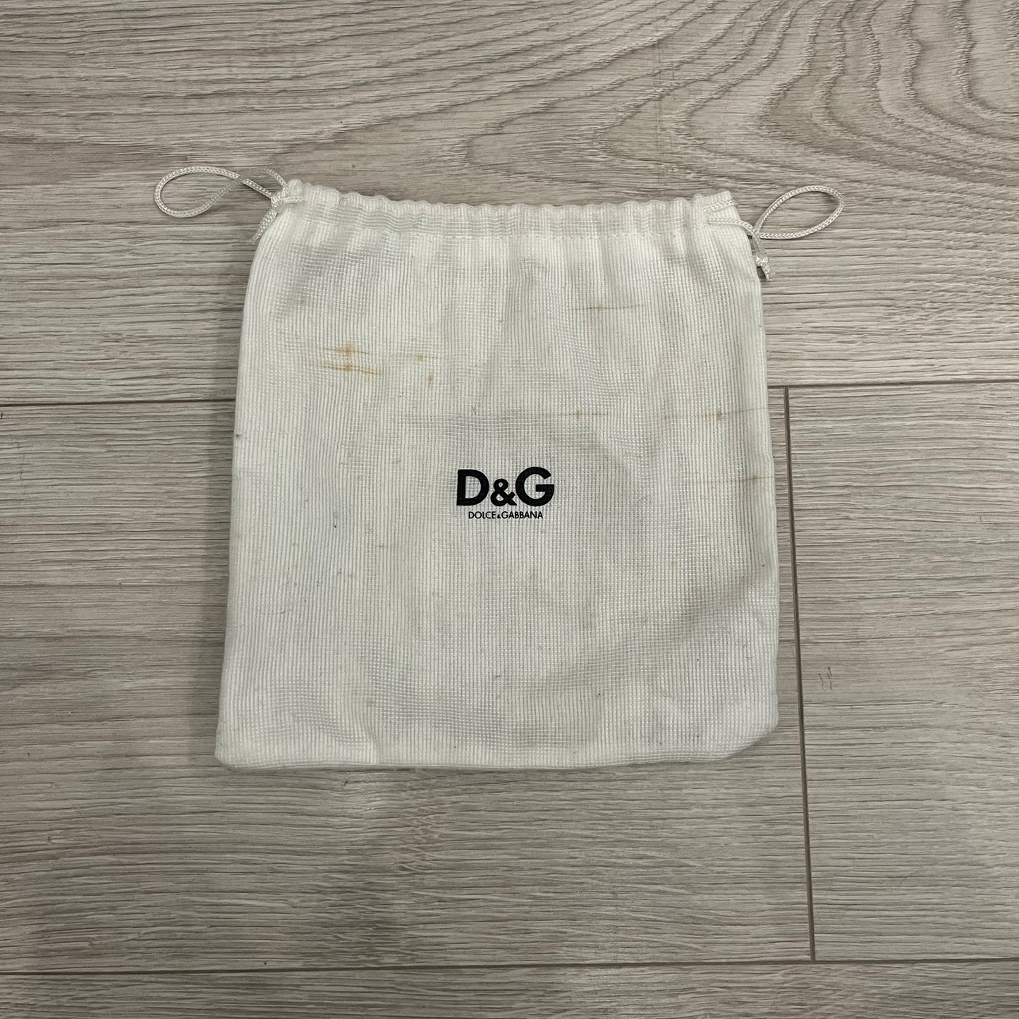 Dolce &amp; Gabbana 2000s Silver/Gold Bars Belt crafted from black leather with a solid metal buckle plate. The buckle features three horizontal metal bars secured with visible screws, with silver-tone bars on the top and bottom and a gold-tone center bar engraved with the D&amp;G logo. Finished with a structured leather strap, comes with the original dustbag.