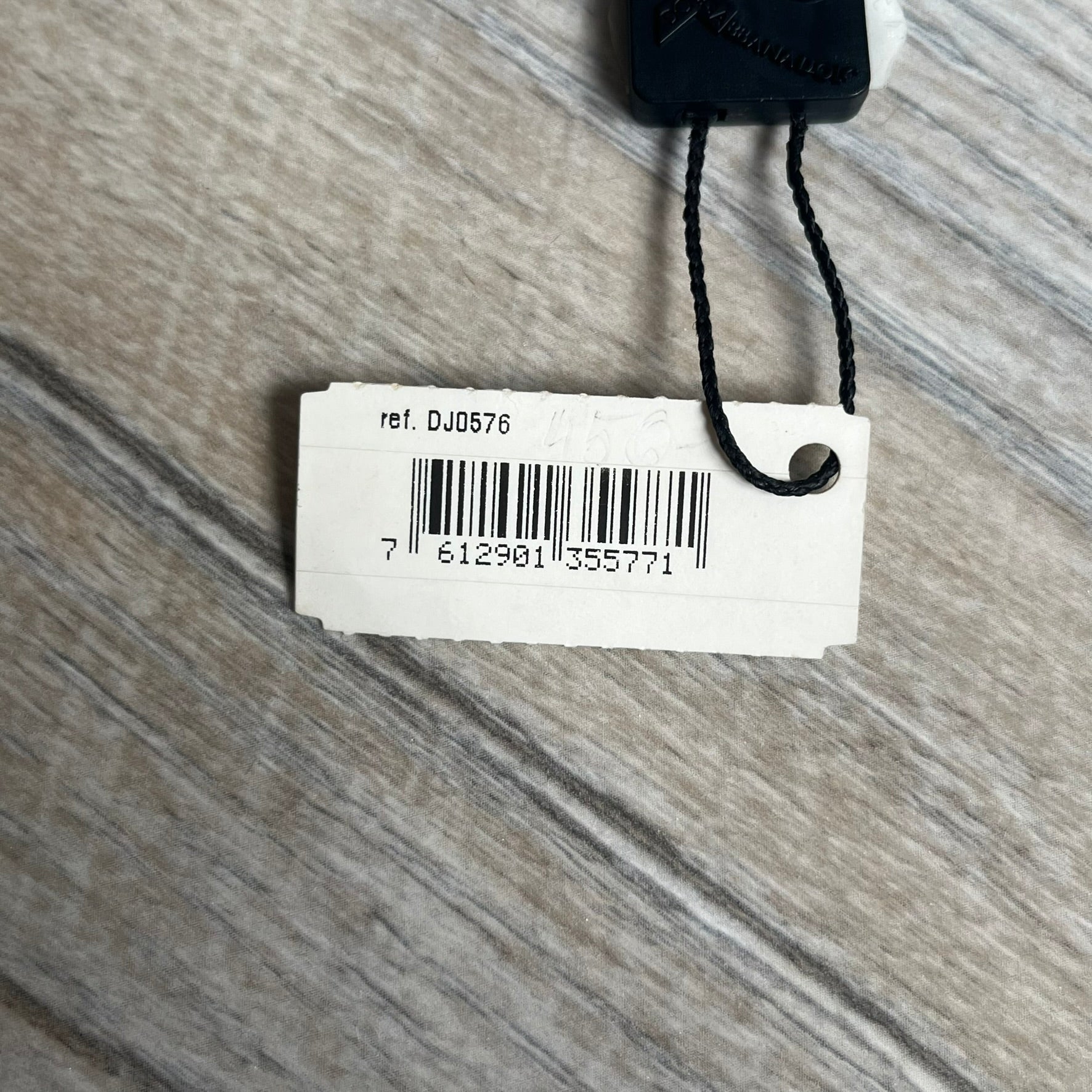 Dolce & Gabbana 2000s Split Black Dog Tag Necklace is a stainless steel necklace featuring a black dog tag pendant with a vertical grey split line running from top to bottom. The lower section of the pendant includes D&G and Dolce & Gabbana logos in the same grey tone as the split detail. The pendant has an iridescent black finish that shifts color depending on the angle. It is attached to a steel ball chain with a lobster clasp closure.