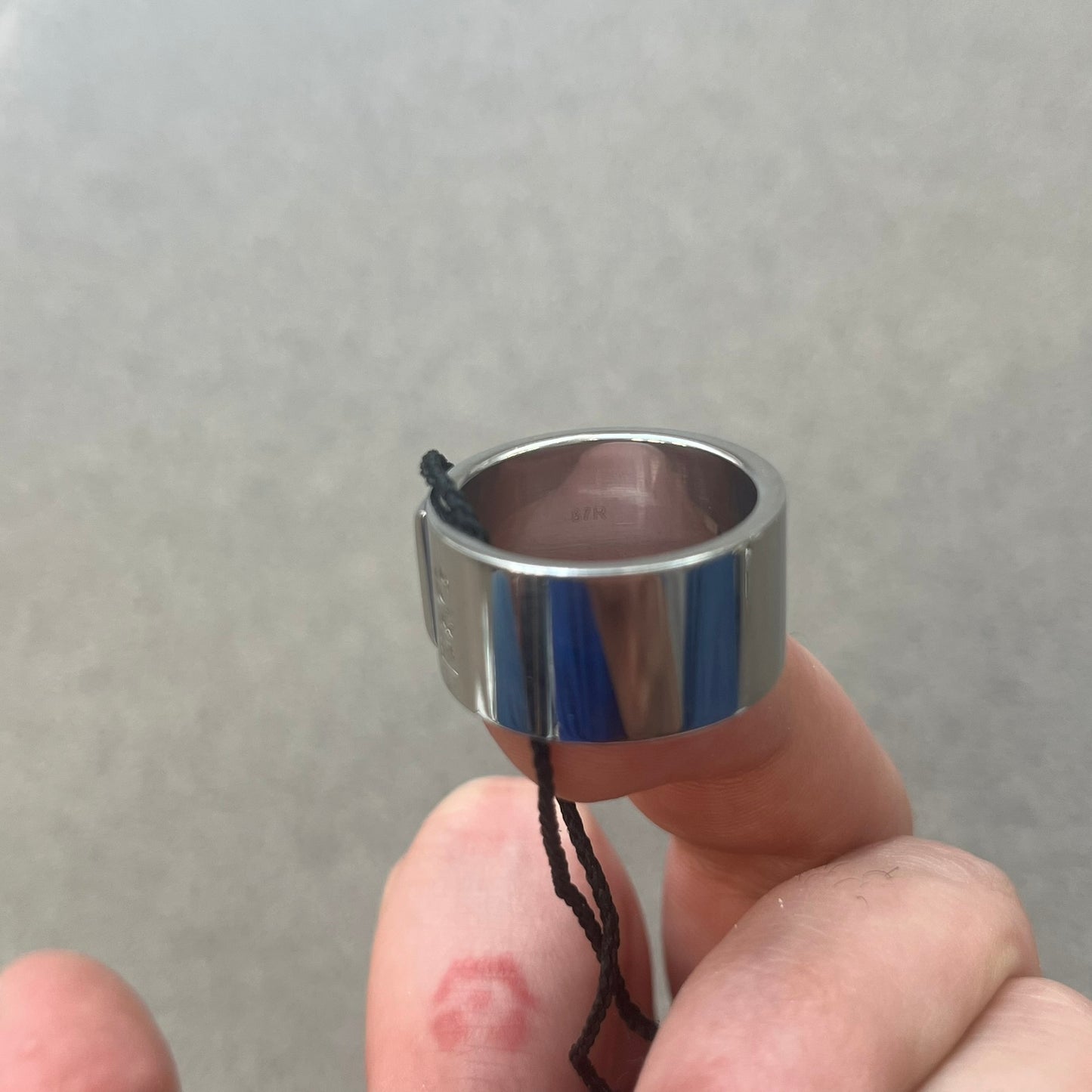 Dolce &amp; Gabbana DJ0836 Ring is made from silver-tone metal and features three raised square elements set across the top. Next to the squares, there is a small engraved D&amp;G logo. The ring has a clean, minimal design and is marked with model code DJ0836.