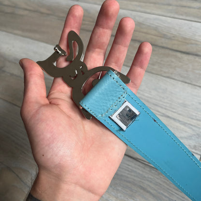 Dolce &amp; Gabbana 2008 Butterfly Buckle Baby Blue Leather Belt from the AW2008 collection. Crafted from smooth Baby Blue leather with visible edge stitching, this belt features a big silver-tone D&amp;G logo buckle shaped in a butterfly-style form. The buckle has a polished metal finish, while the belt itself is made from 100% leather and retains a clean, structured profile. An original seasonal accessory from Dolce &amp; Gabbana’s AW2008 season.