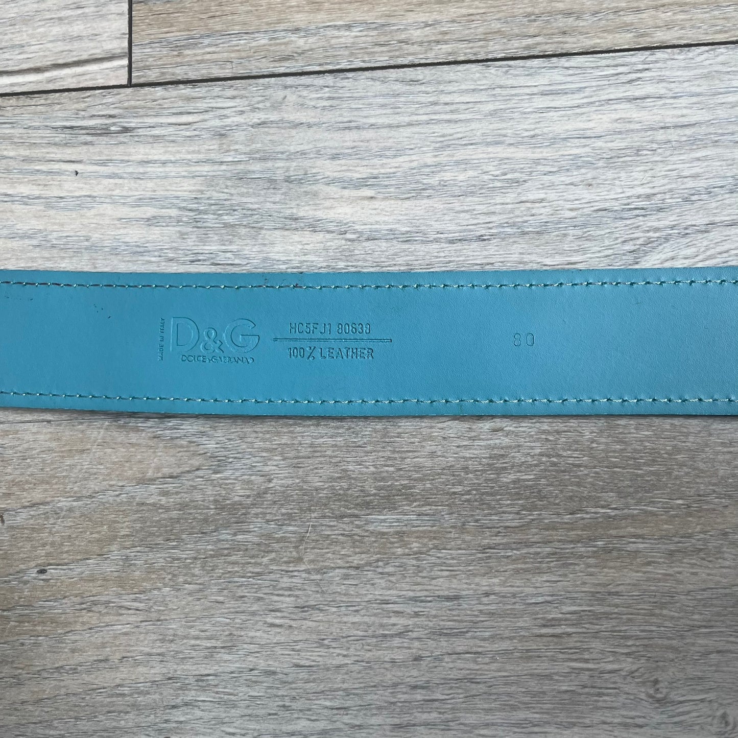 Dolce &amp; Gabbana 2008 Butterfly Buckle Baby Blue Leather Belt from the AW2008 collection. Crafted from smooth Baby Blue leather with visible edge stitching, this belt features a big silver-tone D&amp;G logo buckle shaped in a butterfly-style form. The buckle has a polished metal finish, while the belt itself is made from 100% leather and retains a clean, structured profile. An original seasonal accessory from Dolce &amp; Gabbana’s AW2008 season.