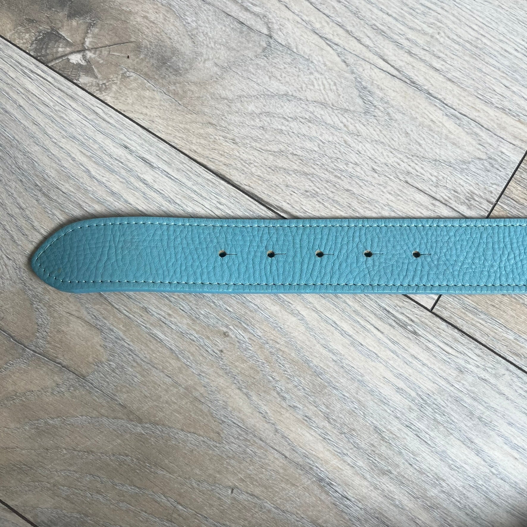 Dolce &amp; Gabbana 2008 Butterfly Buckle Baby Blue Leather Belt from the AW2008 collection. Crafted from smooth Baby Blue leather with visible edge stitching, this belt features a big silver-tone D&amp;G logo buckle shaped in a butterfly-style form. The buckle has a polished metal finish, while the belt itself is made from 100% leather and retains a clean, structured profile. An original seasonal accessory from Dolce &amp; Gabbana’s AW2008 season.