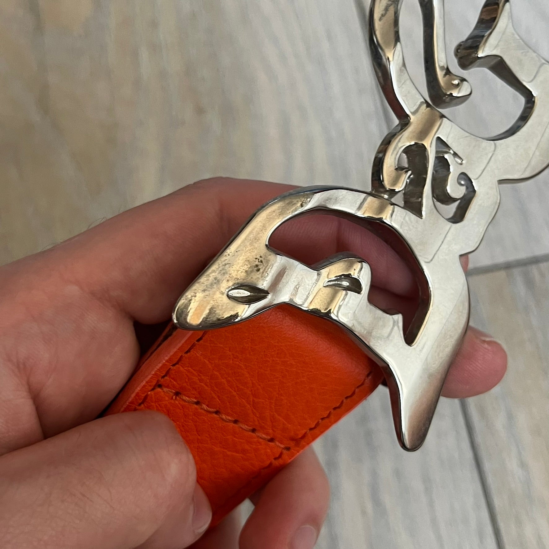 Dolce &amp; Gabbana 2008 Butterfly Buckle Orange Leather Belt from the AW2008 collection. Crafted from smooth orange leather with visible edge stitching, this belt features a big silver-tone D&amp;G logo buckle shaped in a butterfly-style form. The buckle has a polished metal finish, while the belt itself is made from 100% leather and retains a clean, structured profile. An original seasonal accessory from Dolce &amp; Gabbana’s AW2008 season.