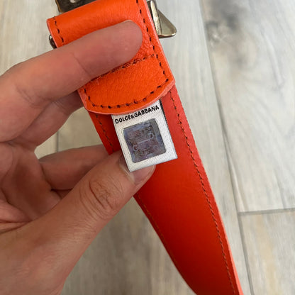 Dolce &amp; Gabbana 2008 Butterfly Buckle Orange Leather Belt from the AW2008 collection. Crafted from smooth orange leather with visible edge stitching, this belt features a big silver-tone D&amp;G logo buckle shaped in a butterfly-style form. The buckle has a polished metal finish, while the belt itself is made from 100% leather and retains a clean, structured profile. An original seasonal accessory from Dolce &amp; Gabbana’s AW2008 season.