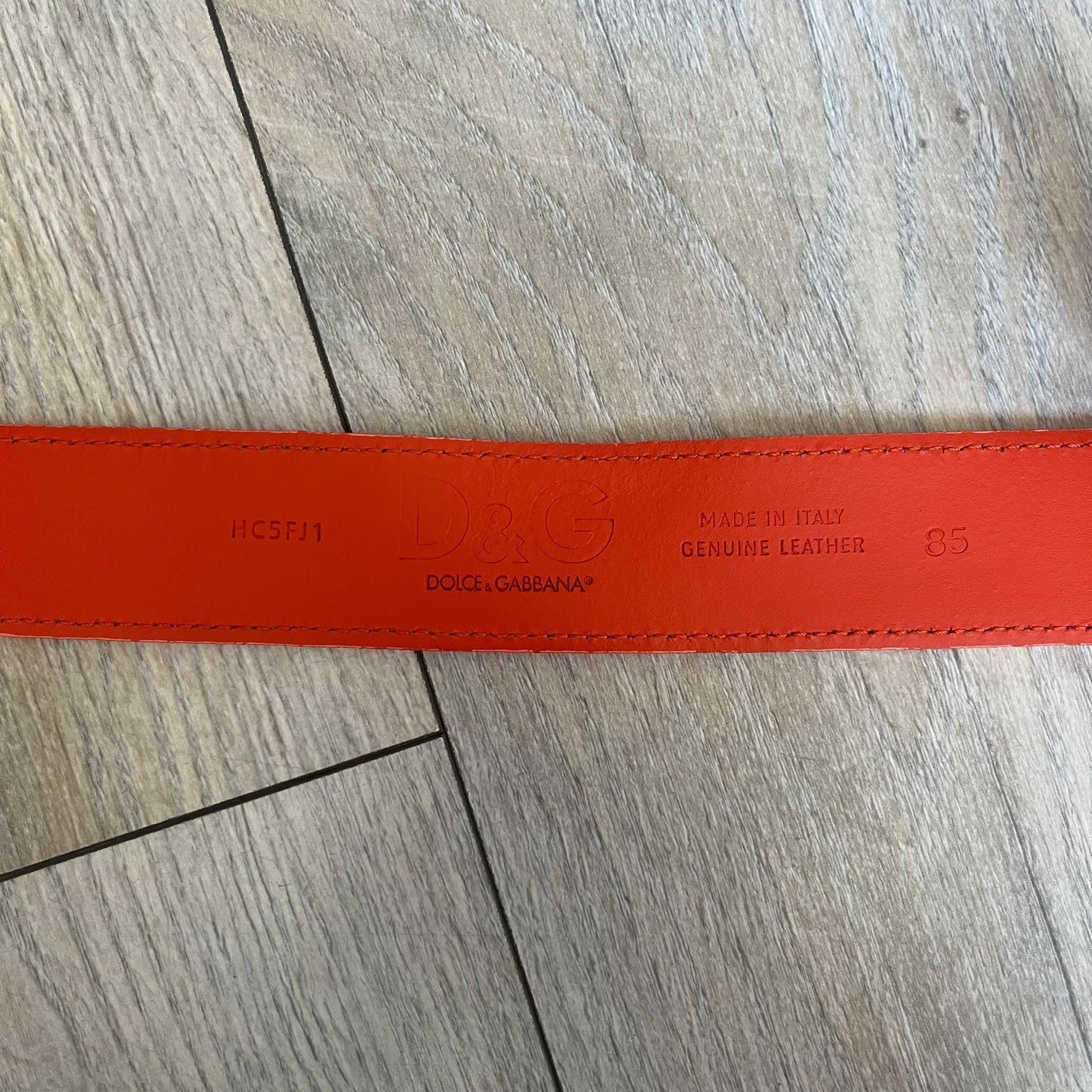 Dolce &amp; Gabbana 2008 Butterfly Buckle Orange Leather Belt from the AW2008 collection. Crafted from smooth orange leather with visible edge stitching, this belt features a big silver-tone D&amp;G logo buckle shaped in a butterfly-style form. The buckle has a polished metal finish, while the belt itself is made from 100% leather and retains a clean, structured profile. An original seasonal accessory from Dolce &amp; Gabbana’s AW2008 season.