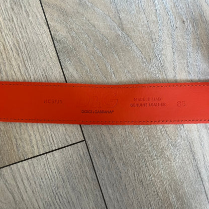 Dolce &amp; Gabbana 2008 Butterfly Buckle Orange Leather Belt from the AW2008 collection. Crafted from smooth orange leather with visible edge stitching, this belt features a big silver-tone D&amp;G logo buckle shaped in a butterfly-style form. The buckle has a polished metal finish, while the belt itself is made from 100% leather and retains a clean, structured profile. An original seasonal accessory from Dolce &amp; Gabbana’s AW2008 season.