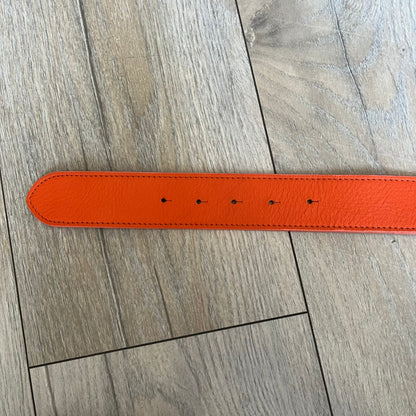 Dolce &amp; Gabbana 2008 Butterfly Buckle Orange Leather Belt from the AW2008 collection. Crafted from smooth orange leather with visible edge stitching, this belt features a big silver-tone D&amp;G logo buckle shaped in a butterfly-style form. The buckle has a polished metal finish, while the belt itself is made from 100% leather and retains a clean, structured profile. An original seasonal accessory from Dolce &amp; Gabbana’s AW2008 season.