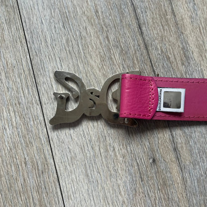 Dolce &amp; Gabbana 2008 Butterfly Buckle Pink Leather Belt from the AW2008 collection. Crafted from smooth pink leather with visible edge stitching, this belt features a big silver-tone D&amp;G logo buckle shaped in a butterfly-style form. The buckle has a polished metal finish, while the belt itself is made from 100% leather and retains a clean, structured profile. An original seasonal accessory from Dolce &amp; Gabbana’s AW2008 season.