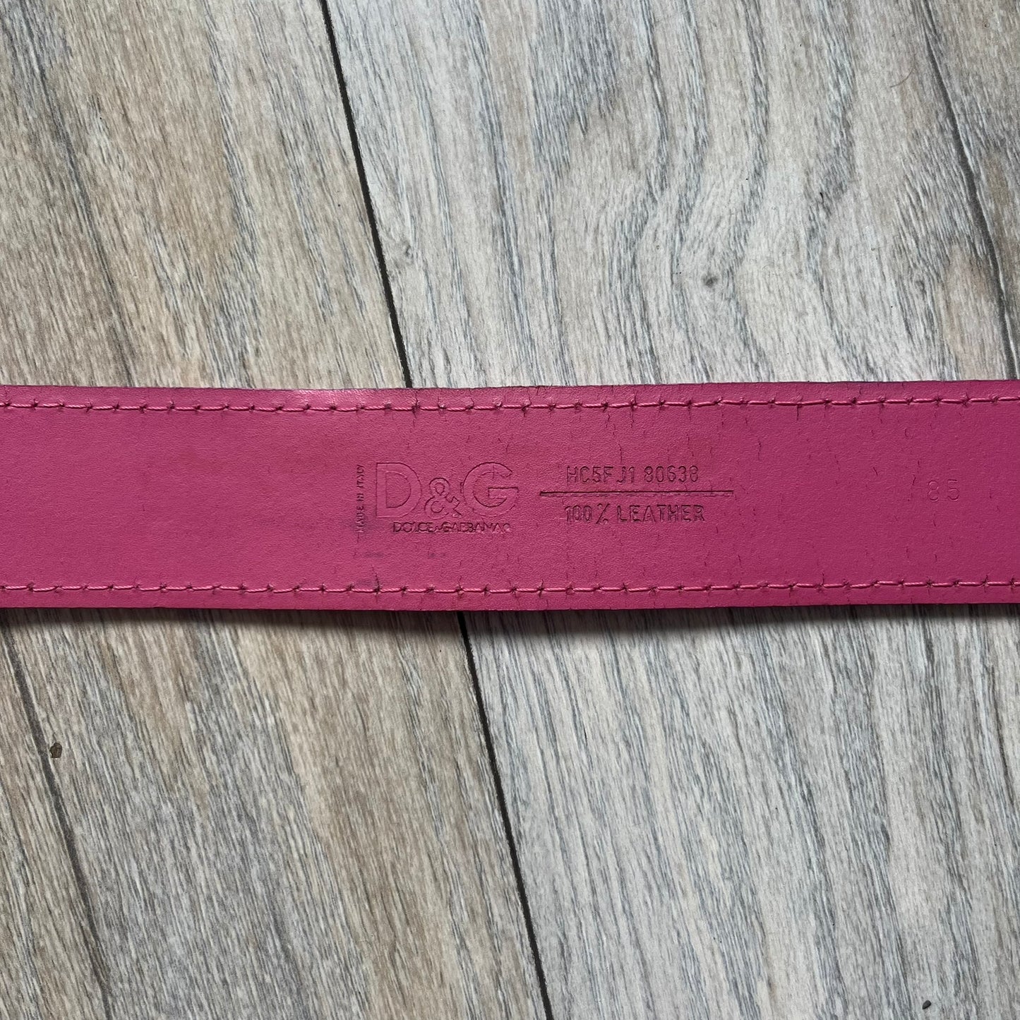 Dolce &amp; Gabbana 2008 Butterfly Buckle Pink Leather Belt from the AW2008 collection. Crafted from smooth pink leather with visible edge stitching, this belt features a big silver-tone D&amp;G logo buckle shaped in a butterfly-style form. The buckle has a polished metal finish, while the belt itself is made from 100% leather and retains a clean, structured profile. An original seasonal accessory from Dolce &amp; Gabbana’s AW2008 season.