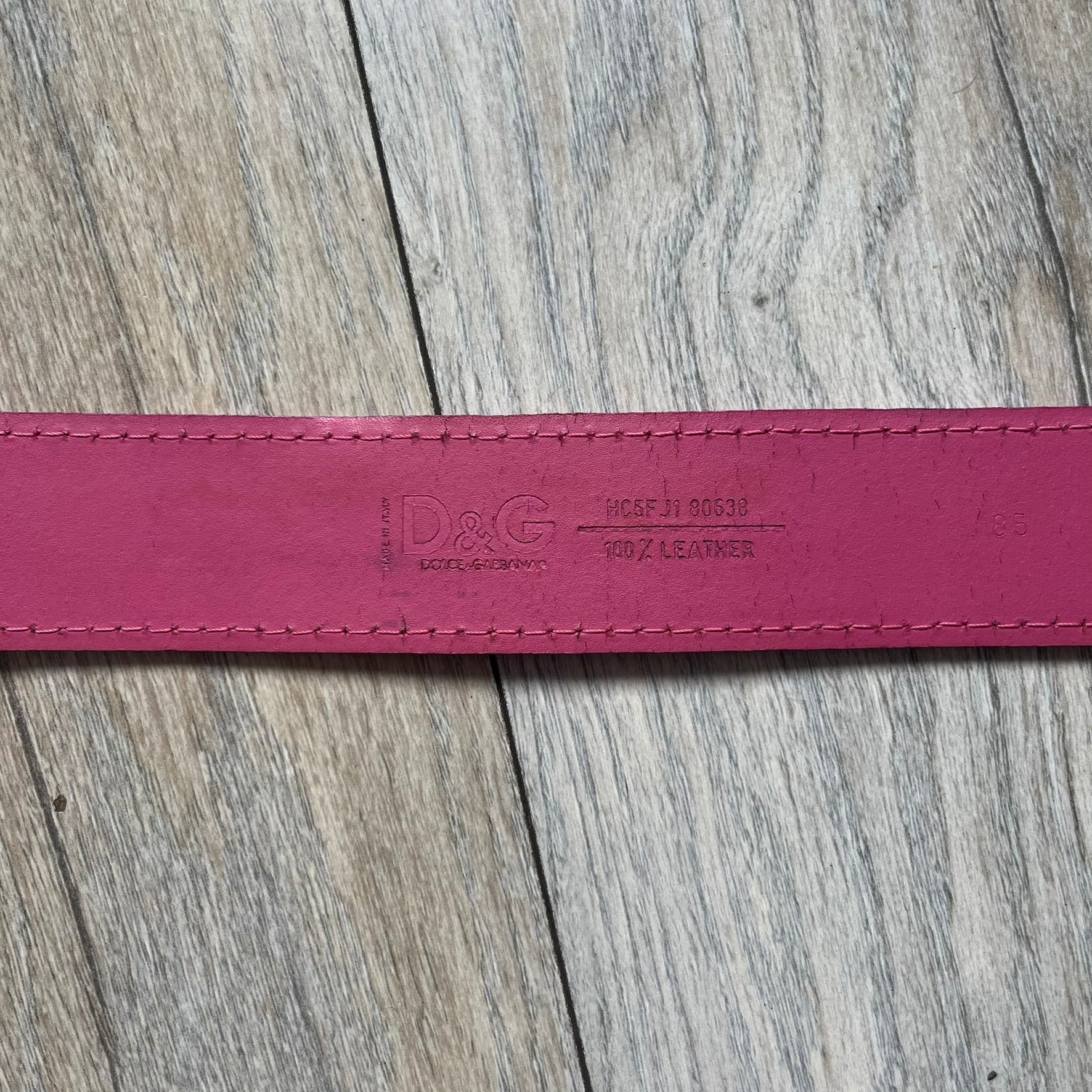Dolce &amp; Gabbana 2008 Butterfly Buckle Pink Leather Belt from the AW2008 collection. Crafted from smooth pink leather with visible edge stitching, this belt features a big silver-tone D&amp;G logo buckle shaped in a butterfly-style form. The buckle has a polished metal finish, while the belt itself is made from 100% leather and retains a clean, structured profile. An original seasonal accessory from Dolce &amp; Gabbana’s AW2008 season.