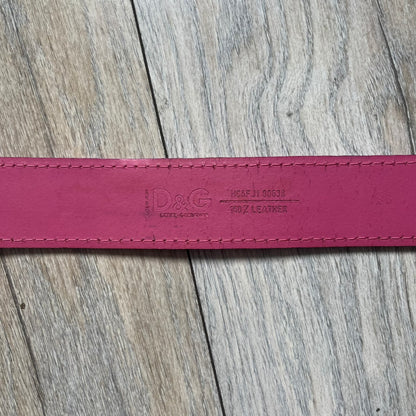 Dolce &amp; Gabbana 2008 Butterfly Buckle Pink Leather Belt from the AW2008 collection. Crafted from smooth pink leather with visible edge stitching, this belt features a big silver-tone D&amp;G logo buckle shaped in a butterfly-style form. The buckle has a polished metal finish, while the belt itself is made from 100% leather and retains a clean, structured profile. An original seasonal accessory from Dolce &amp; Gabbana’s AW2008 season.