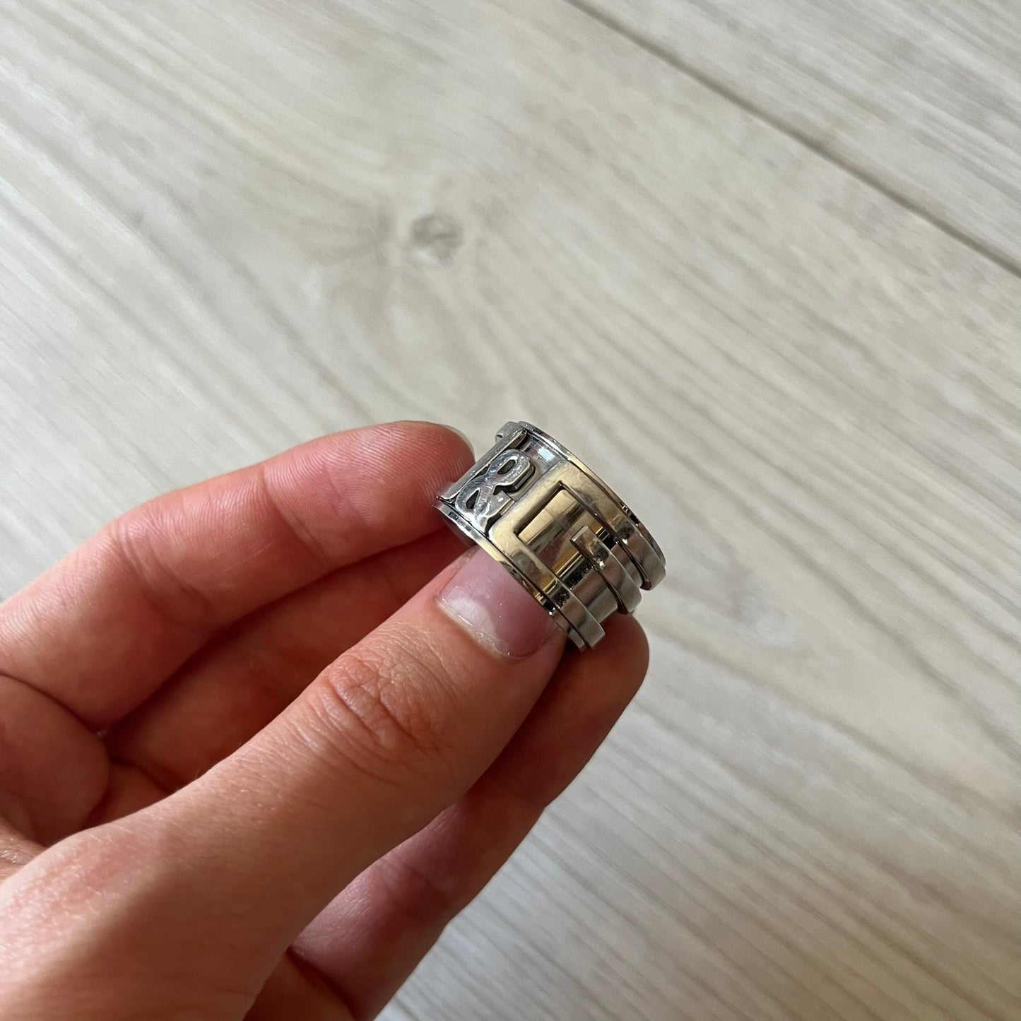 Dolce &amp; Gabbana 3D logo ring crafted in silver-tone metal with a unique two-part construction. The base is a classic band, topped with a raised layer that wraps the D&amp;G logo around the ring. Designed with a movable top section that spins, it’s a dynamic accessory merging playful function with signature branding.