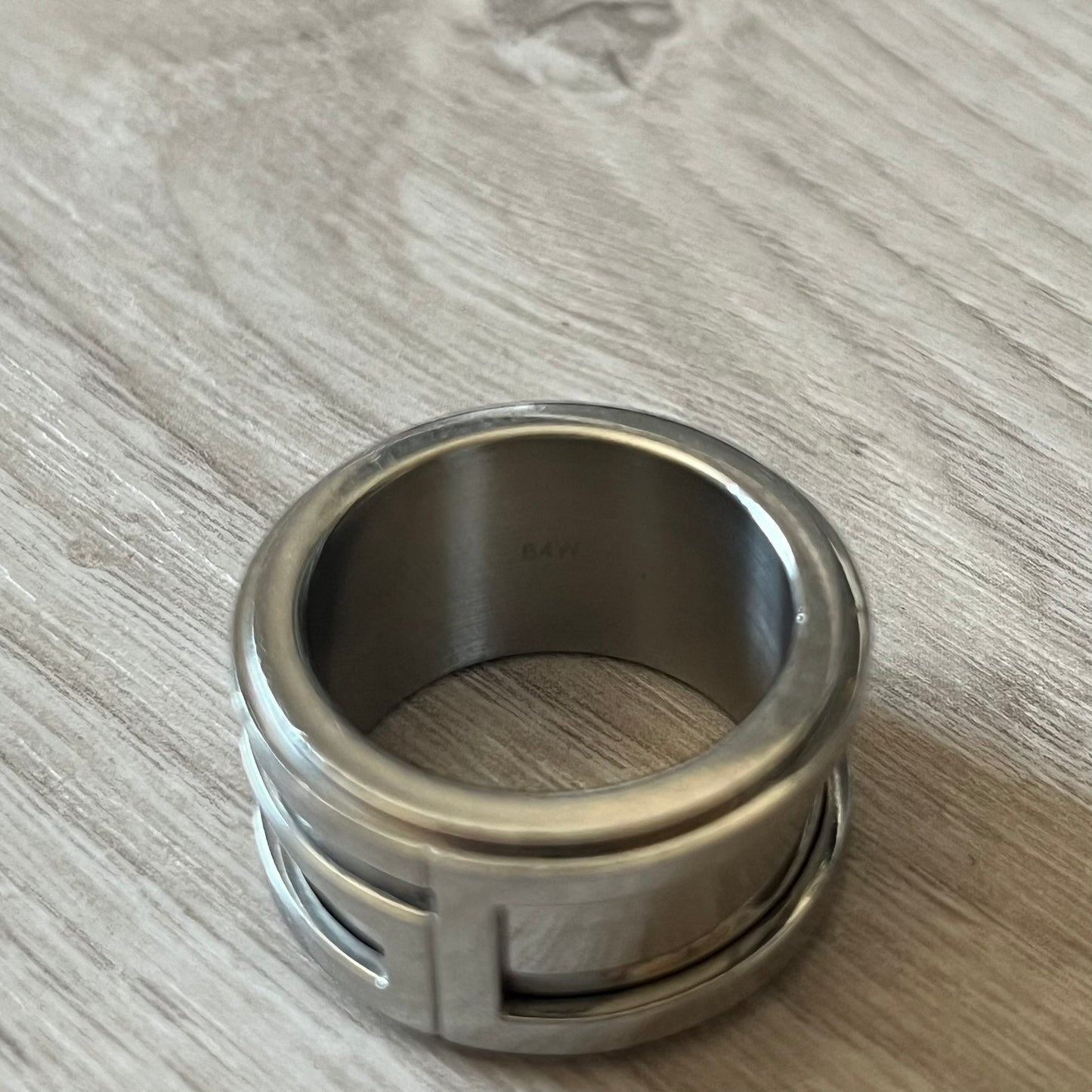 Dolce &amp; Gabbana 3D logo ring crafted in silver-tone metal with a unique two-part construction. The base is a classic band, topped with a raised layer that wraps the D&amp;G logo around the ring. Designed with a movable top section that spins, it’s a dynamic accessory merging playful function with signature branding.