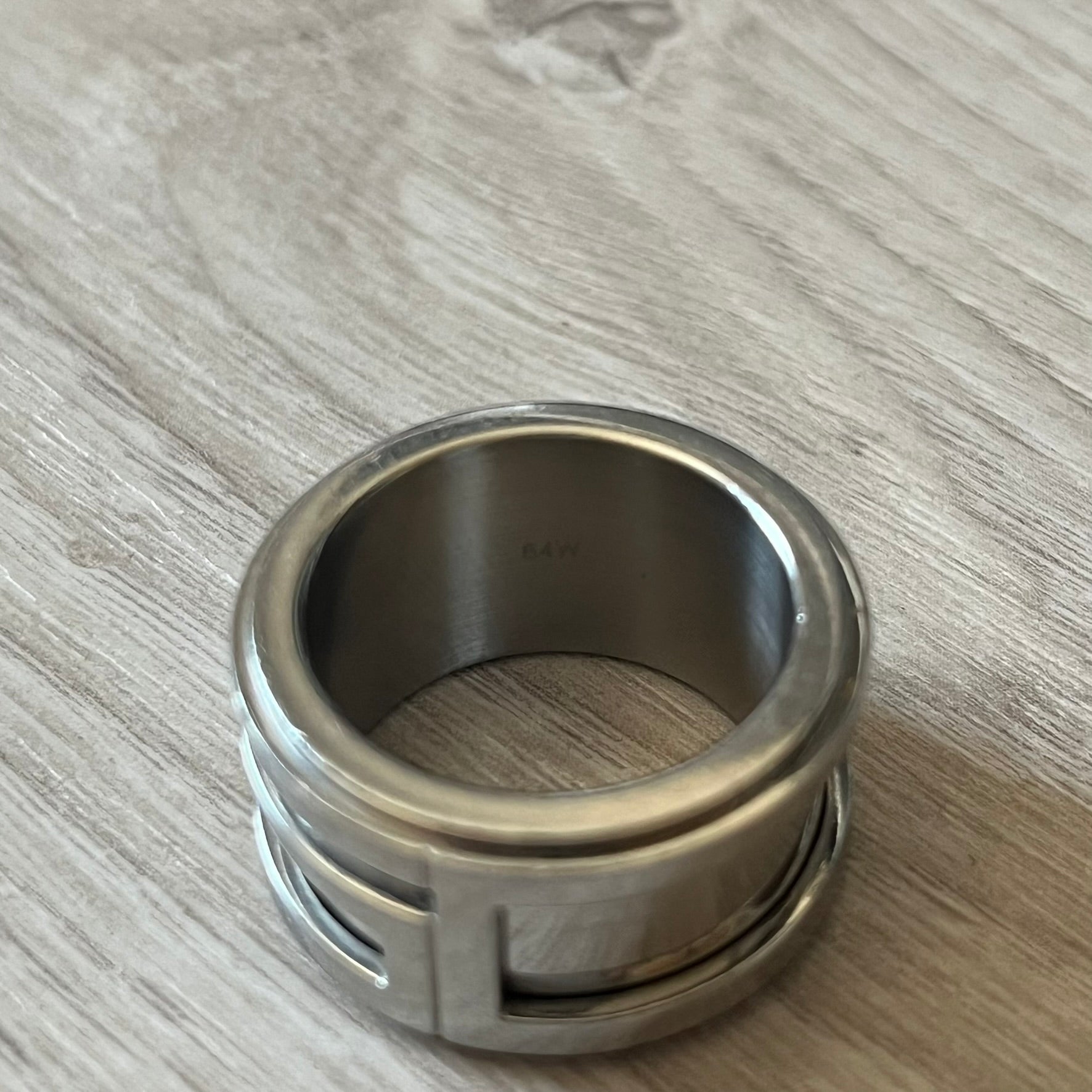 Dolce &amp; Gabbana 3D logo ring crafted in silver-tone metal with a unique two-part construction. The base is a classic band, topped with a raised layer that wraps the D&amp;G logo around the ring. Designed with a movable top section that spins, it’s a dynamic accessory merging playful function with signature branding.