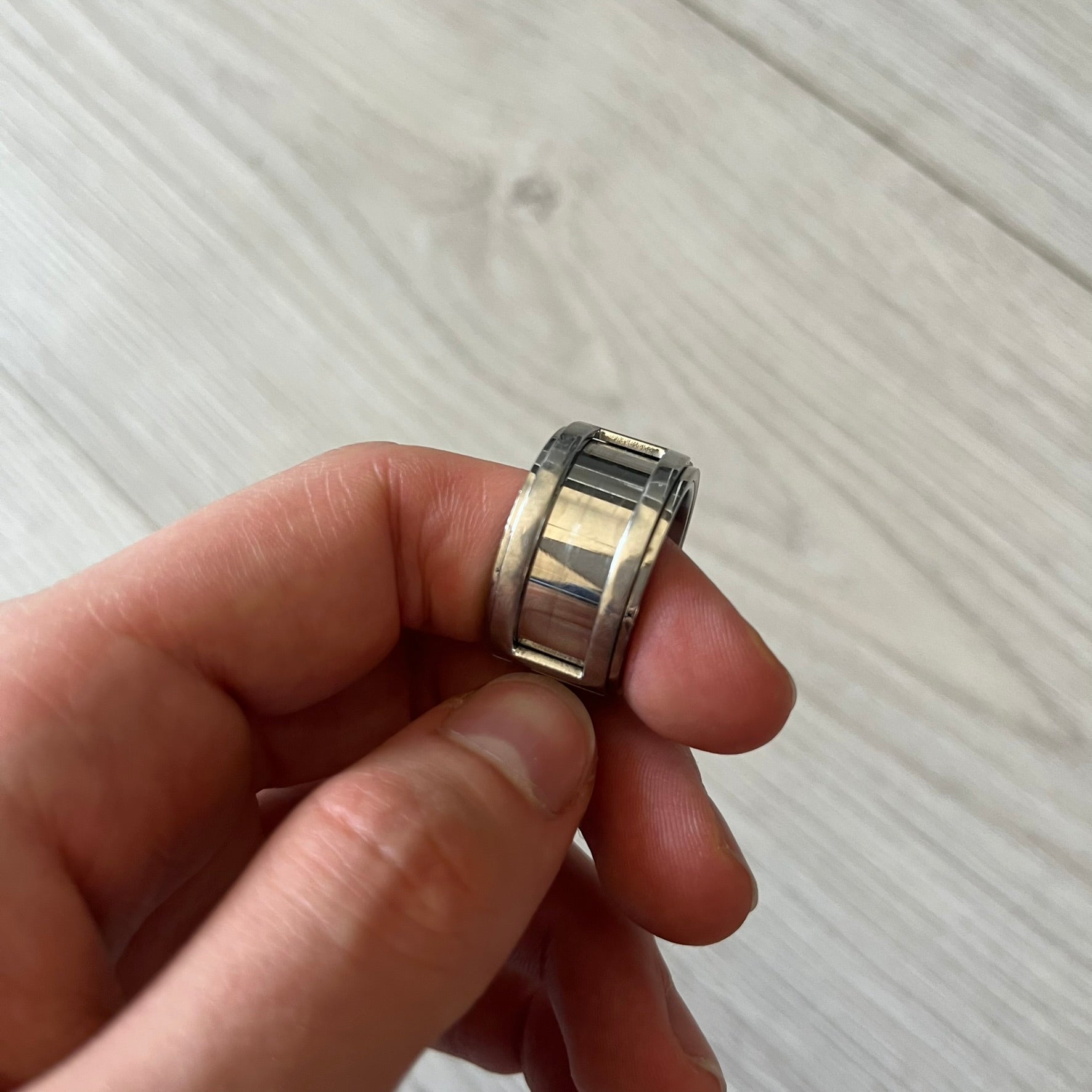 Dolce &amp; Gabbana 3D logo ring crafted in silver-tone metal with a unique two-part construction. The base is a classic band, topped with a raised layer that wraps the D&amp;G logo around the ring. Designed with a movable top section that spins, it’s a dynamic accessory merging playful function with signature branding.