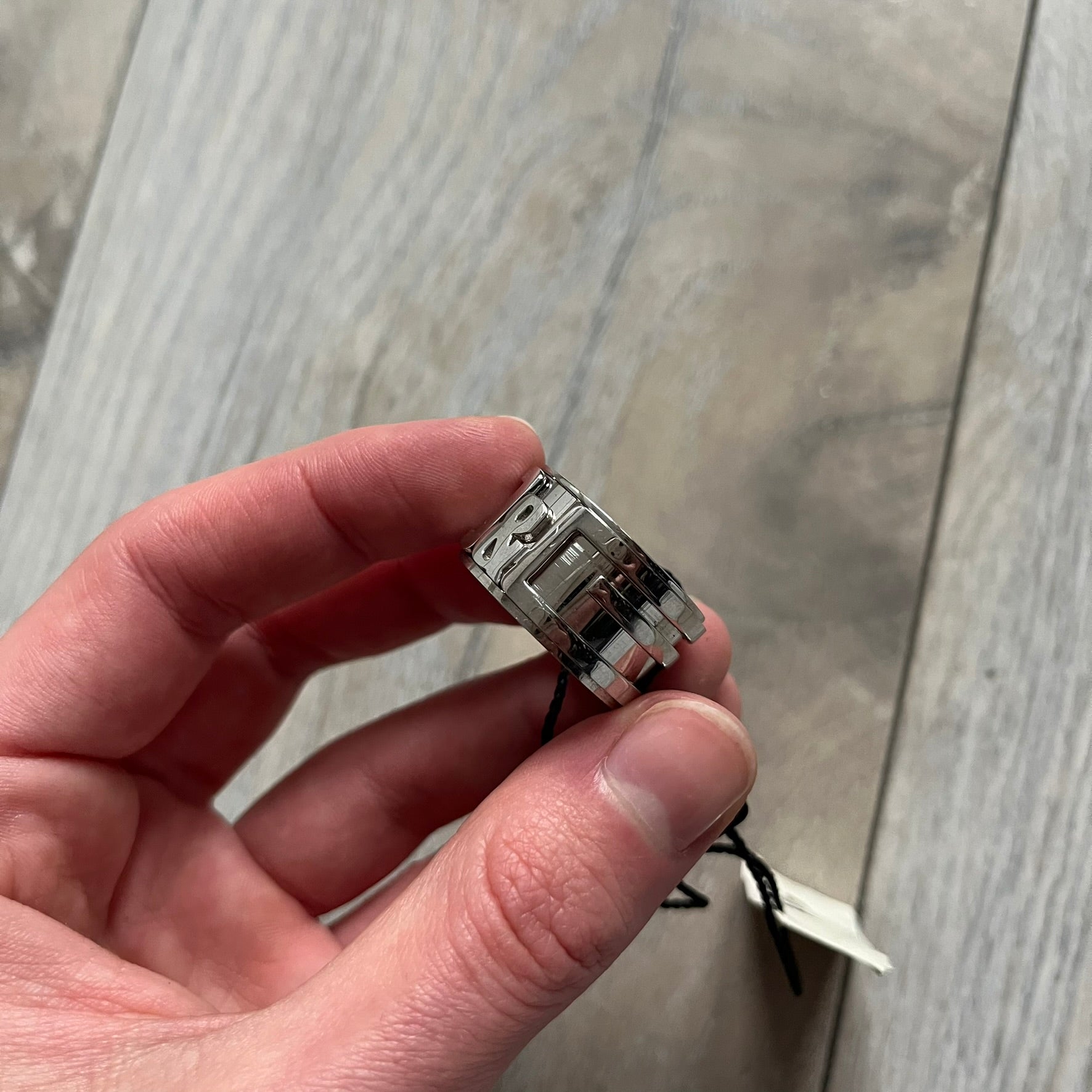 Dolce &amp; Gabbana 3D logo ring crafted in silver-tone metal with a unique two-part construction. The base is a classic band, topped with a raised layer that wraps the D&amp;G logo around the ring. Designed with a movable top section that spins, it’s a dynamic accessory merging playful function with signature branding.