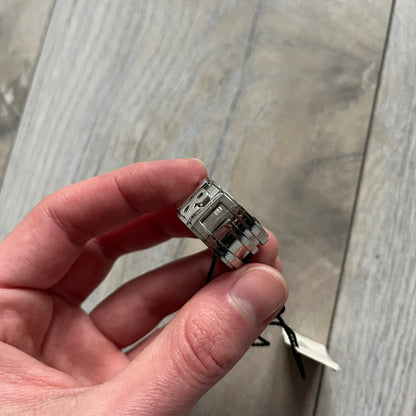 Dolce &amp; Gabbana 3D logo ring crafted in silver-tone metal with a unique two-part construction. The base is a classic band, topped with a raised layer that wraps the D&amp;G logo around the ring. Designed with a movable top section that spins, it’s a dynamic accessory merging playful function with signature branding.