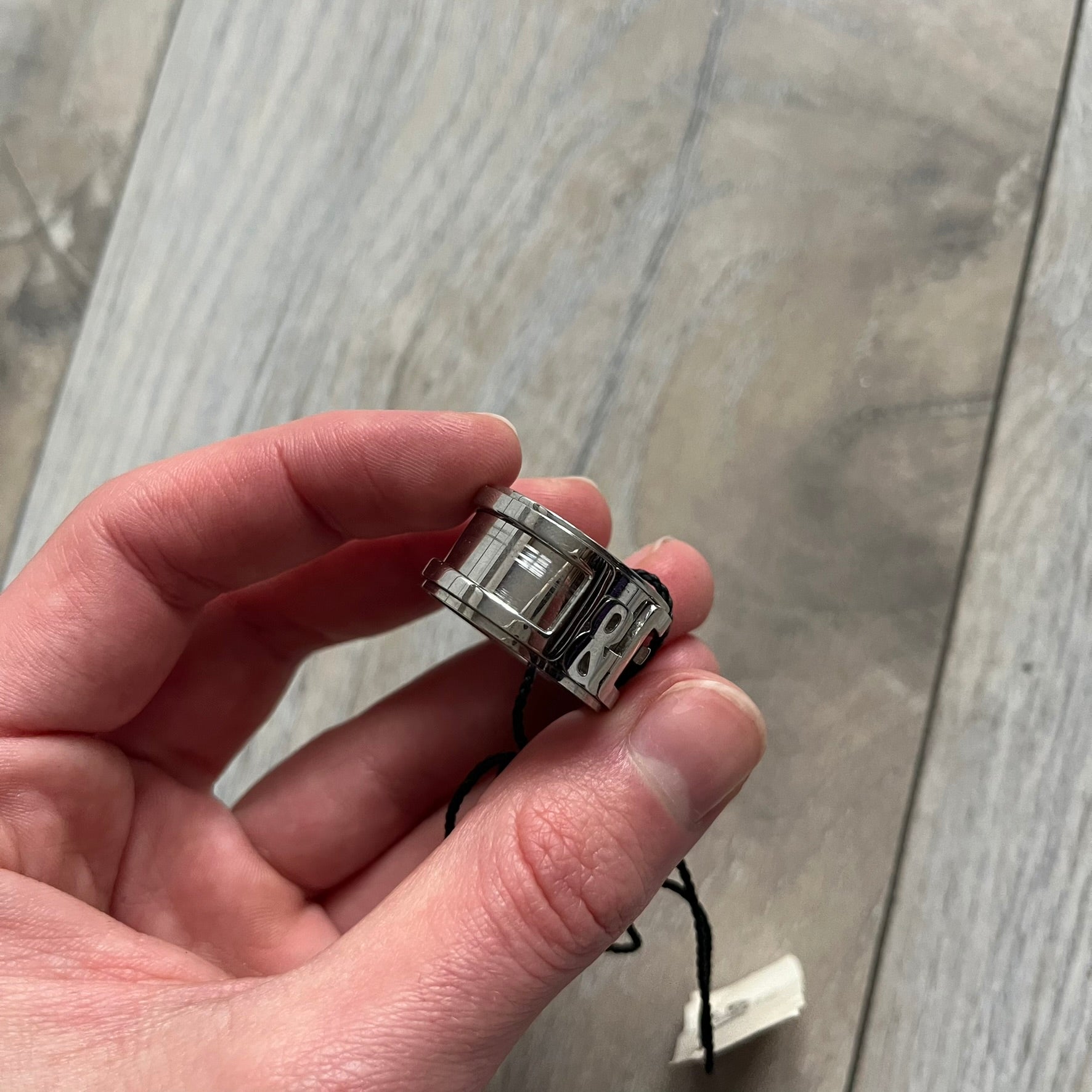 Dolce &amp; Gabbana 3D logo ring crafted in silver-tone metal with a unique two-part construction. The base is a classic band, topped with a raised layer that wraps the D&amp;G logo around the ring. Designed with a movable top section that spins, it’s a dynamic accessory merging playful function with signature branding.