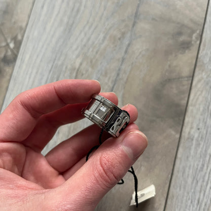 Dolce &amp; Gabbana 3D logo ring crafted in silver-tone metal with a unique two-part construction. The base is a classic band, topped with a raised layer that wraps the D&amp;G logo around the ring. Designed with a movable top section that spins, it’s a dynamic accessory merging playful function with signature branding.