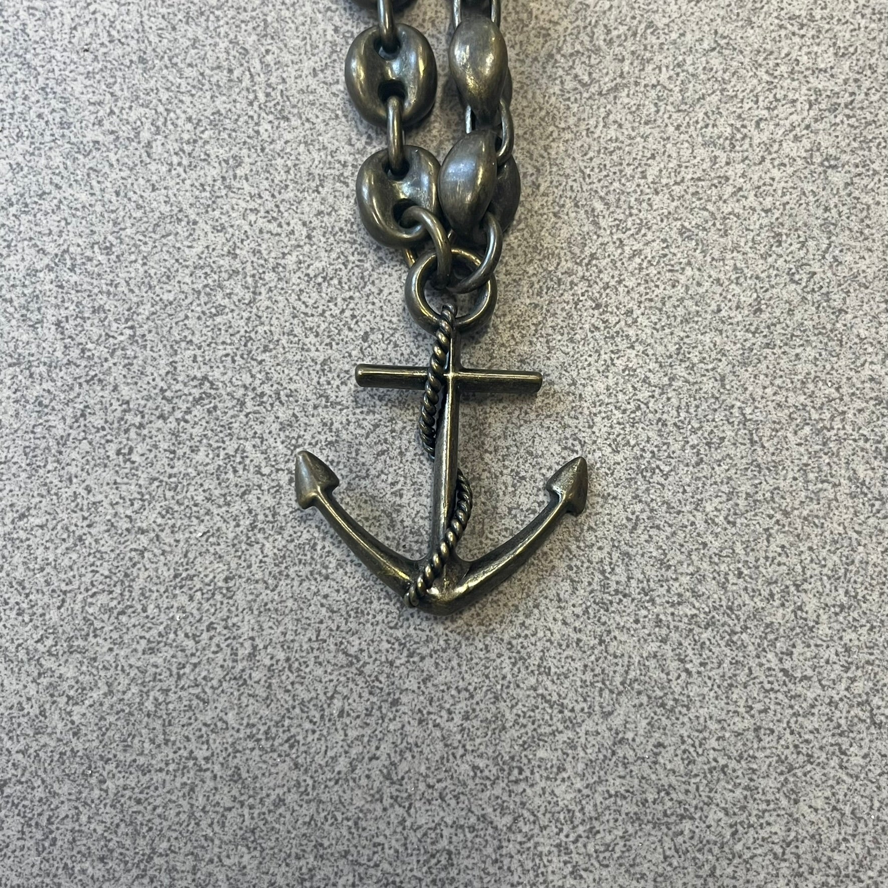 Dolce &amp; Gabbana AW2006 Anchor Necklace features a thick, heavy necklace with a dirty gold-tone finish and oversized mariner links. One of the links is detailed with an engraved D&amp;G logo plaque. The main pendant is a large anchor wrapped with a rope motif, matching the rugged nautical-inspired design of the necklace.