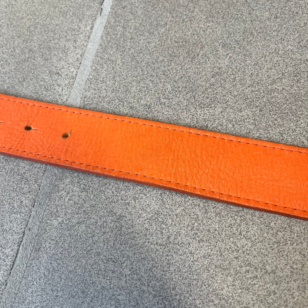 Dolce &amp; Gabbana 2008 Butterfly Buckle Orange Leather Belt from the AW2008 collection. Crafted from smooth orange leather with visible edge stitching, this belt features a big silver-tone D&amp;G logo buckle shaped in a butterfly-style form. The buckle has a polished metal finish, while the belt itself is made from 100% leather and retains a clean, structured profile. An original seasonal accessory from Dolce &amp; Gabbana’s AW2008 season.