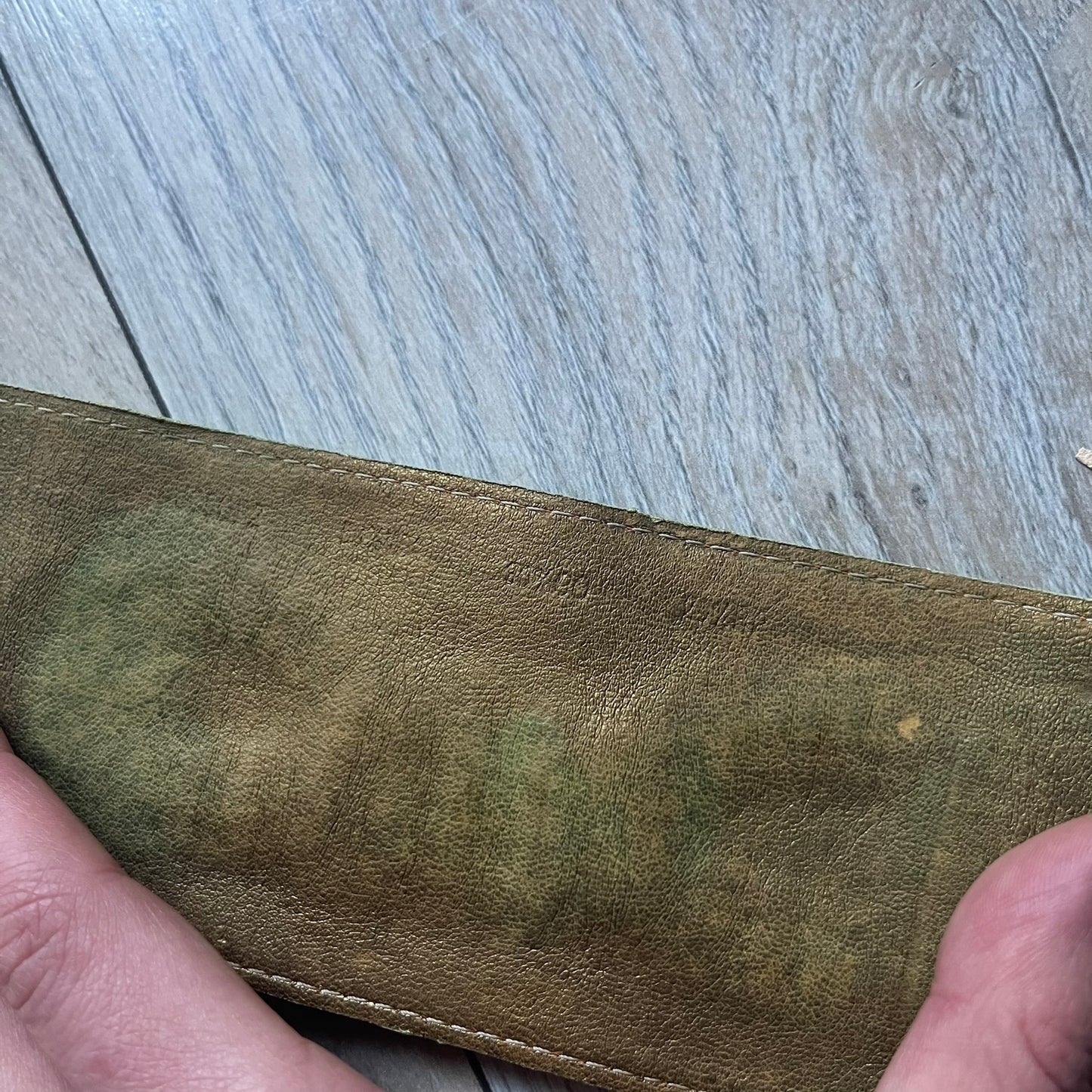 The Dolce &amp; Gabbana Big Green Leather Bracelet is a tall green leather wristband featuring a layered D&amp;G logo along its length - an orange base layer with a green logo on top, detailed with visible orange stitching. The inside has a Dolce &amp; Gabbana tag, and it closes with two metal buttons, offering four total button positions for adjustable sizing.