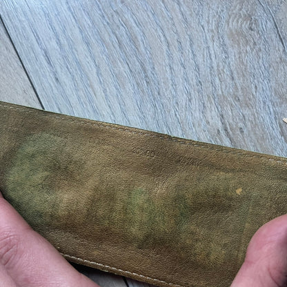 The Dolce &amp; Gabbana Big Green Leather Bracelet is a tall green leather wristband featuring a layered D&amp;G logo along its length - an orange base layer with a green logo on top, detailed with visible orange stitching. The inside has a Dolce &amp; Gabbana tag, and it closes with two metal buttons, offering four total button positions for adjustable sizing.