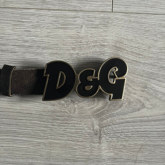 Dolce & Gabbana Black Enamel Belt featuring a D&G logo buckle in black enamel with gold-tone outline. Crafted from brown leather with a gold-tone interior, this belt combines sleek design with subtle luxury detailing.