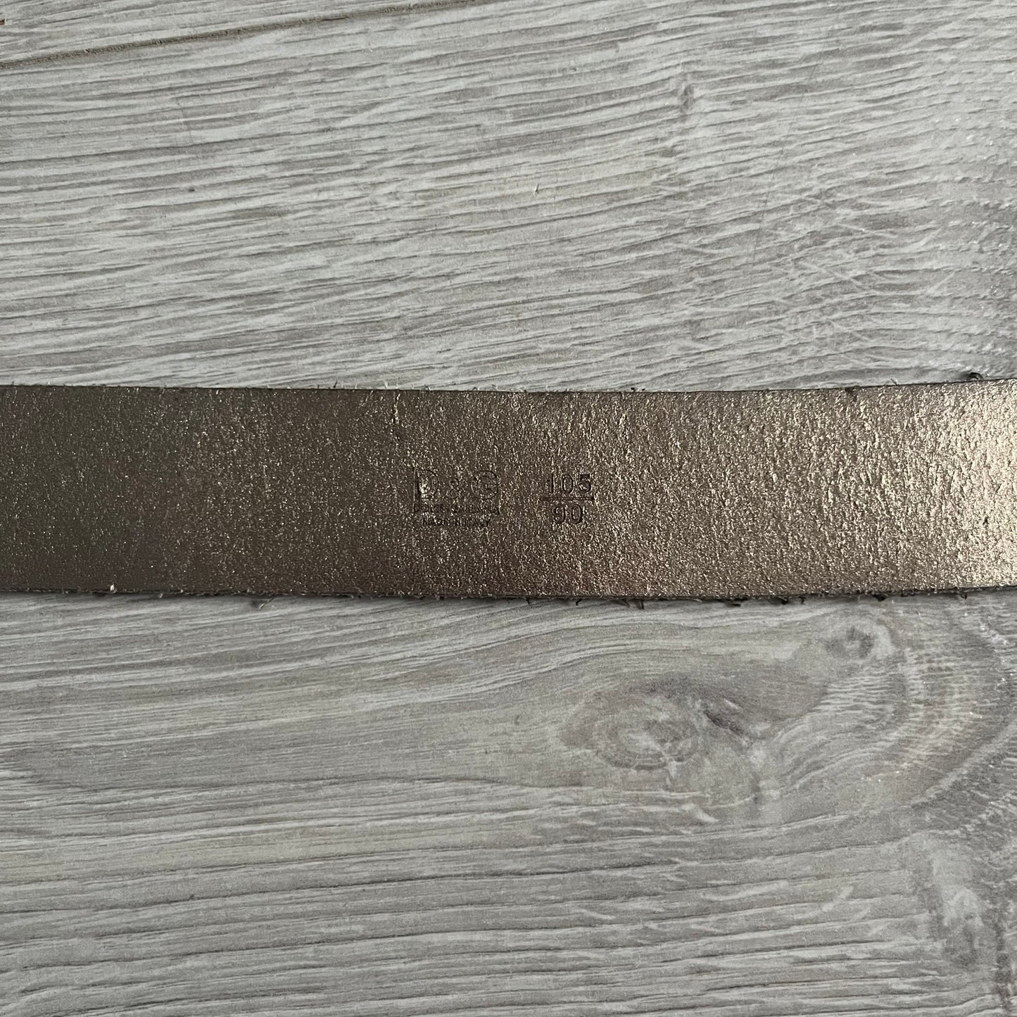 Dolce & Gabbana Black Enamel Belt featuring a D&G logo buckle in black enamel with gold-tone outline. Crafted from brown leather with a gold-tone interior, this belt combines sleek design with subtle luxury detailing.