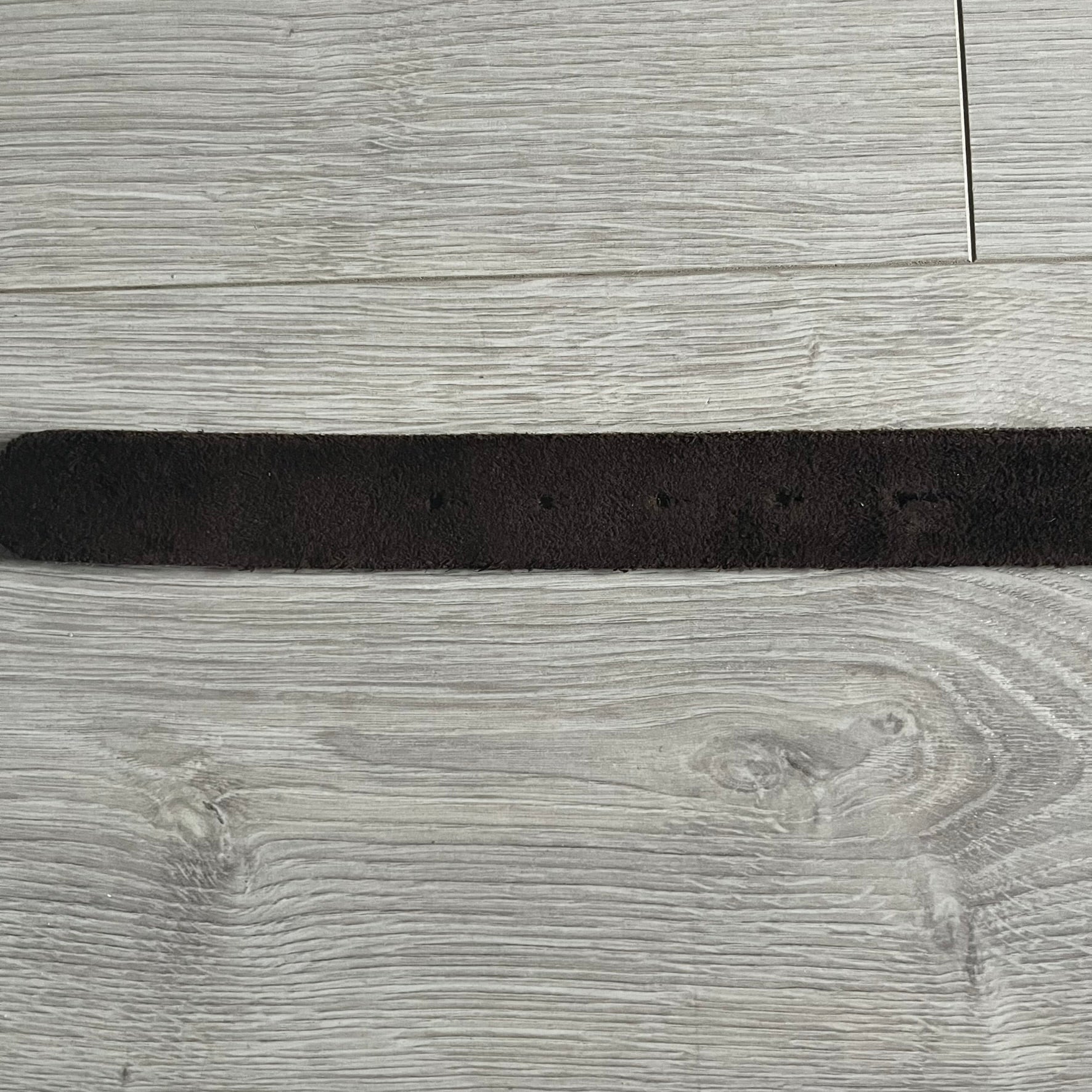 Dolce & Gabbana Black Enamel Belt featuring a D&G logo buckle in black enamel with gold-tone outline. Crafted from brown leather with a gold-tone interior, this belt combines sleek design with subtle luxury detailing.