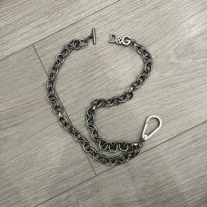 Dolce &amp; Gabbana Carabiner Chain Necklace features a robust stainless steel chain with a central carabiner engraved with the D&amp;G logo. The adjustable design includes a bolt-style clasp to modify the length, and the opposite end showcases a three-dimensional D&amp;G logo, blending industrial detailing with high-fashion appeal.