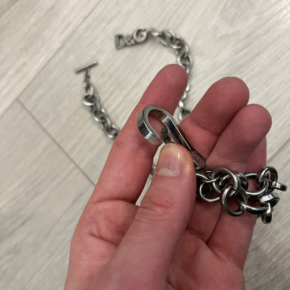 Dolce &amp; Gabbana Carabiner Chain Necklace features a robust stainless steel chain with a central carabiner engraved with the D&amp;G logo. The adjustable design includes a bolt-style clasp to modify the length, and the opposite end showcases a three-dimensional D&amp;G logo, blending industrial detailing with high-fashion appeal.