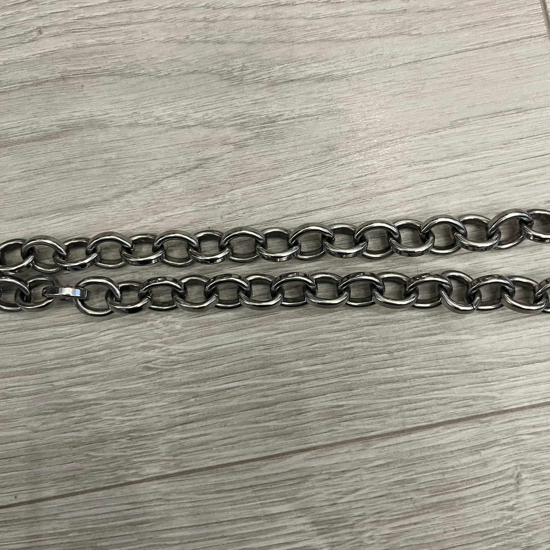Dolce &amp; Gabbana Carabiner Chain Necklace features a robust stainless steel chain with a central carabiner engraved with the D&amp;G logo. The adjustable design includes a bolt-style clasp to modify the length, and the opposite end showcases a three-dimensional D&amp;G logo, blending industrial detailing with high-fashion appeal.