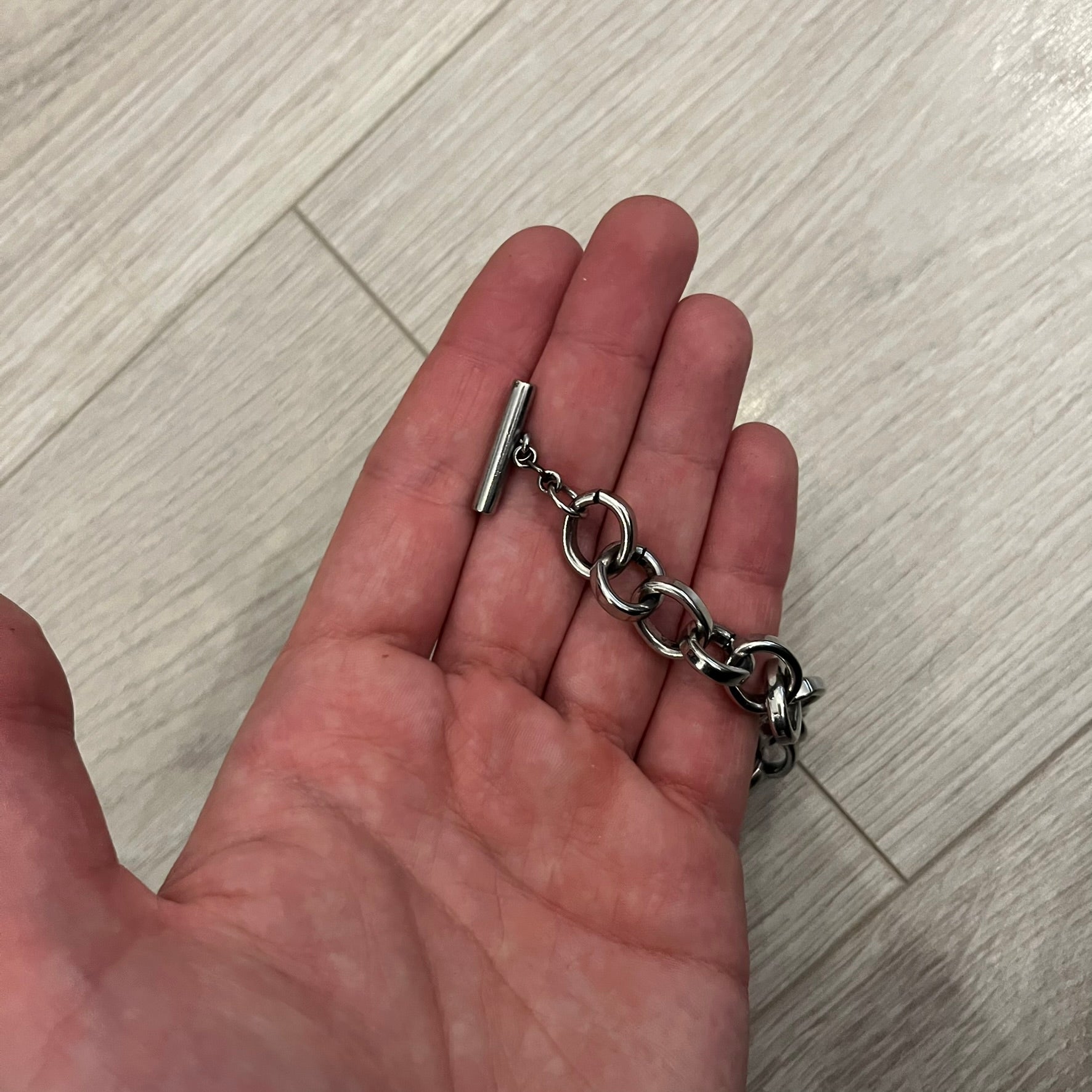 Dolce &amp; Gabbana Carabiner Chain Necklace features a robust stainless steel chain with a central carabiner engraved with the D&amp;G logo. The adjustable design includes a bolt-style clasp to modify the length, and the opposite end showcases a three-dimensional D&amp;G logo, blending industrial detailing with high-fashion appeal.