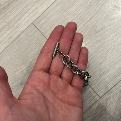 Dolce &amp; Gabbana Carabiner Chain Necklace features a robust stainless steel chain with a central carabiner engraved with the D&amp;G logo. The adjustable design includes a bolt-style clasp to modify the length, and the opposite end showcases a three-dimensional D&amp;G logo, blending industrial detailing with high-fashion appeal.