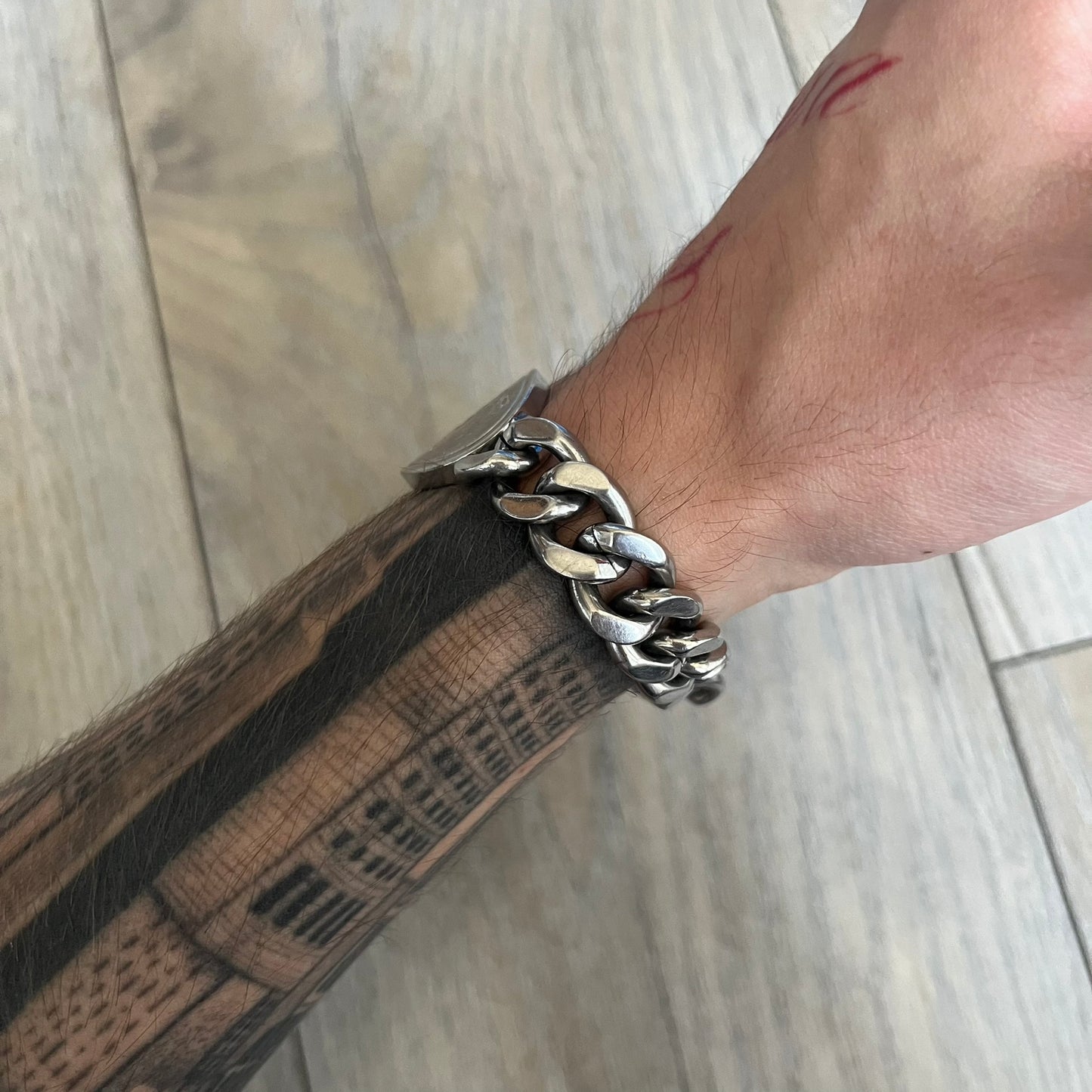 Dolce &amp; Gabbana Champagne Bracelet DJ1092 is a stainless steel bracelet. The silver-tone metal plate is shaped like a D&amp;G champagne label and displays a black D&amp;G logo, along with engraved “Glamorous Champagne 1994 Alc. 12% by Vol.” text. The back of the plate features a large, shallow engraved D&amp;G logo. Retailed at 125 usd in 2000's.