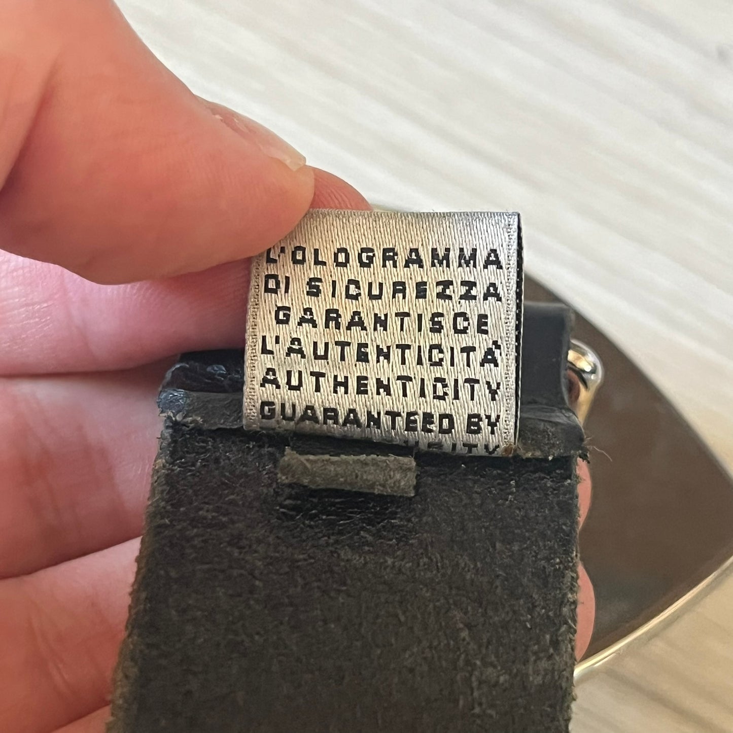  Dolce &amp; Gabbana “College Since 1994” belt featuring a pretty big crest-shaped buckle. The silver text overlays a white-and-black split crest, paired with a soft black leather strap for a refined yet edgy finish.