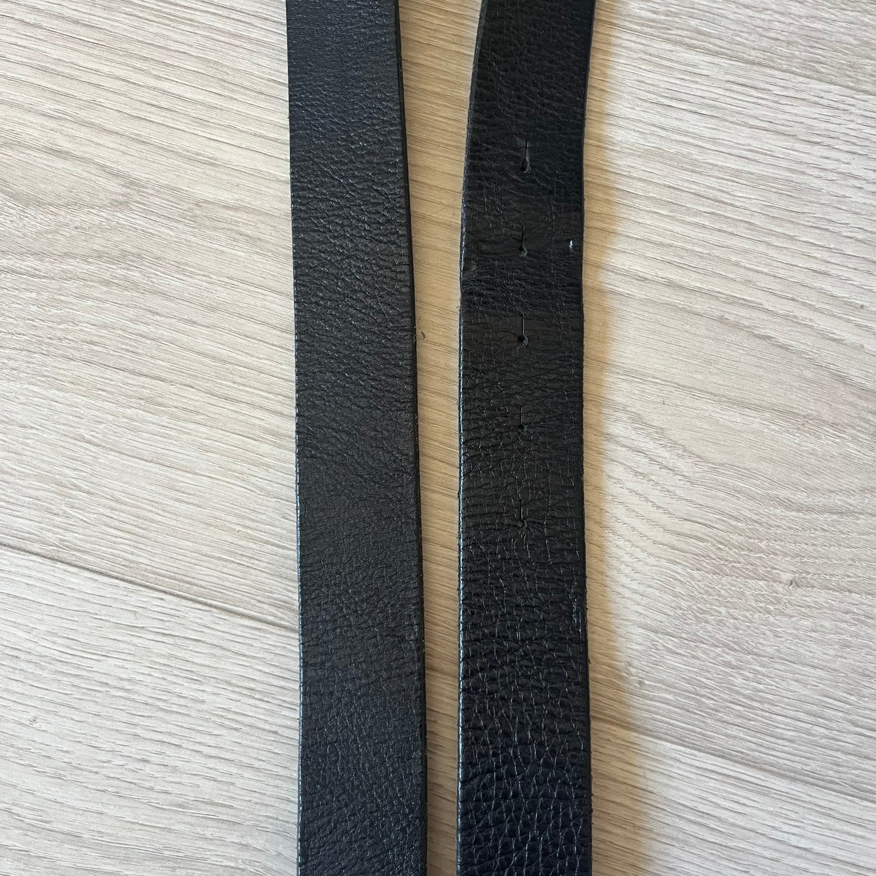  Dolce &amp; Gabbana “College Since 1994” belt featuring a pretty big crest-shaped buckle. The silver text overlays a white-and-black split crest, paired with a soft black leather strap for a refined yet edgy finish.