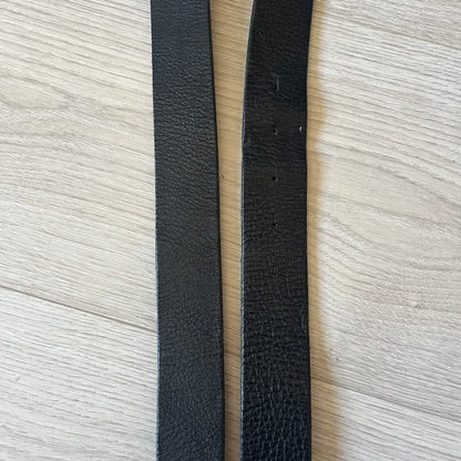  Dolce &amp; Gabbana “College Since 1994” belt featuring a pretty big crest-shaped buckle. The silver text overlays a white-and-black split crest, paired with a soft black leather strap for a refined yet edgy finish.