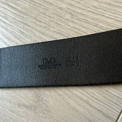  Dolce &amp; Gabbana “College Since 1994” belt featuring a pretty big crest-shaped buckle. The silver text overlays a white-and-black split crest, paired with a soft black leather strap for a refined yet edgy finish.