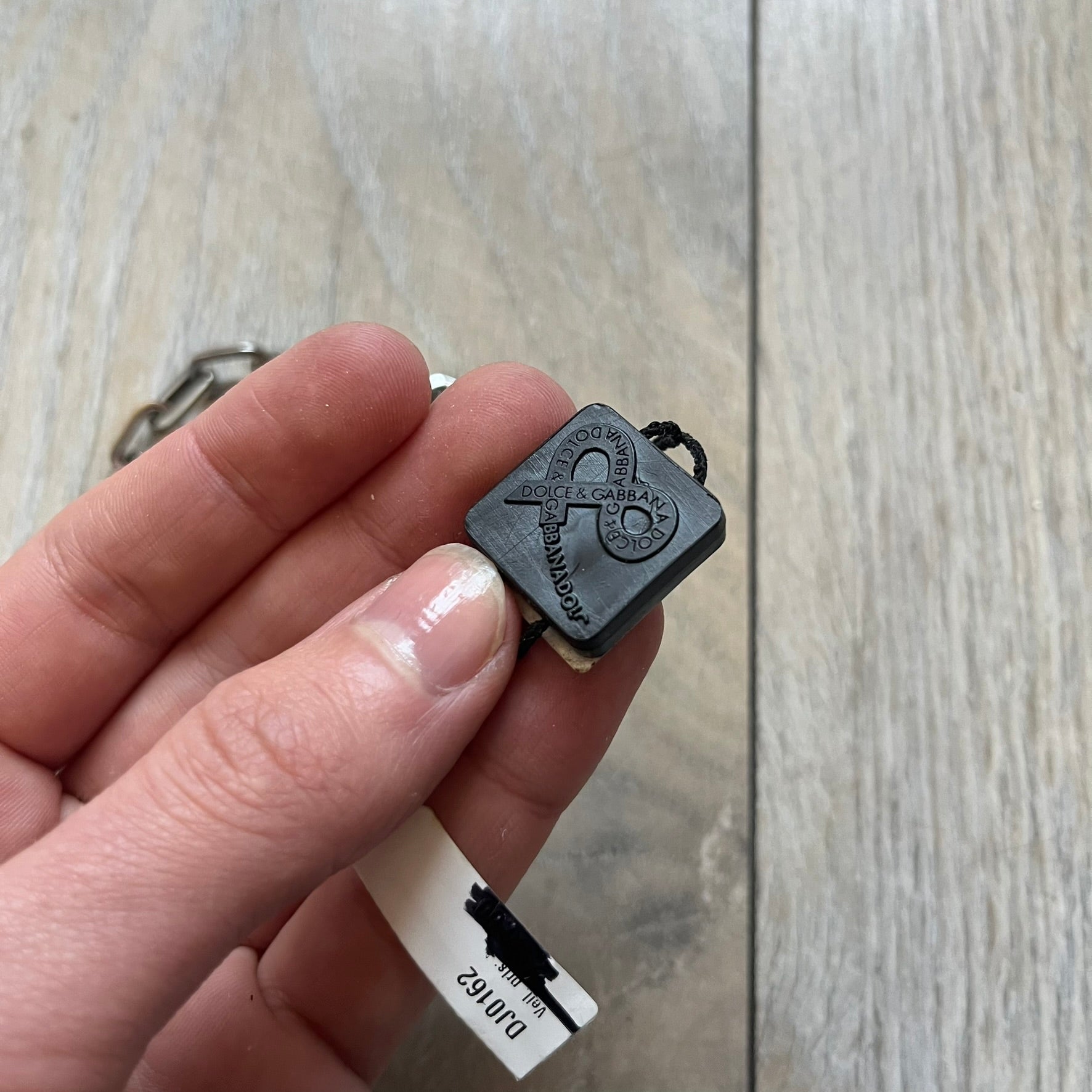 Dolce & Gabbana DJ0162 stainless steel bracelet designed as part of a multi-bracelet watch set, where three bracelets were supplied with the original watch. The piece features a paperclip chain construction and a T-bar clasp fastening. D&G branding appears engraved on the T-bar and on the circular ring element of the clasp.
